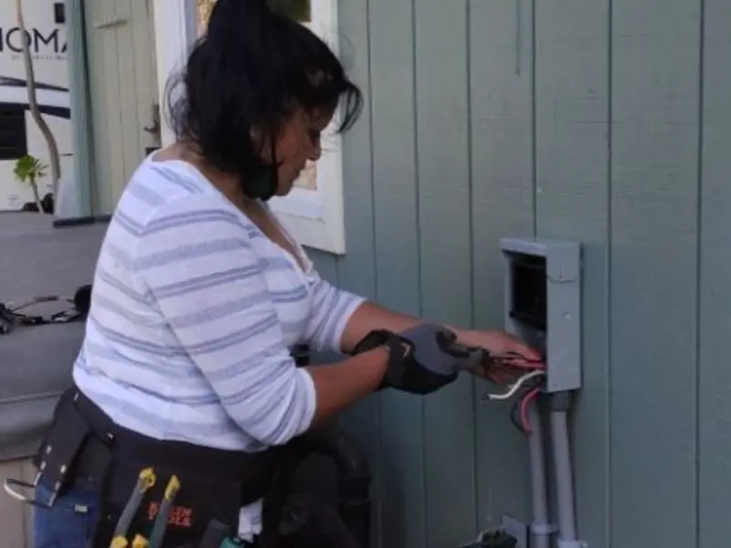 Licensed electrician wiring an exterior subpanel in Oceanside