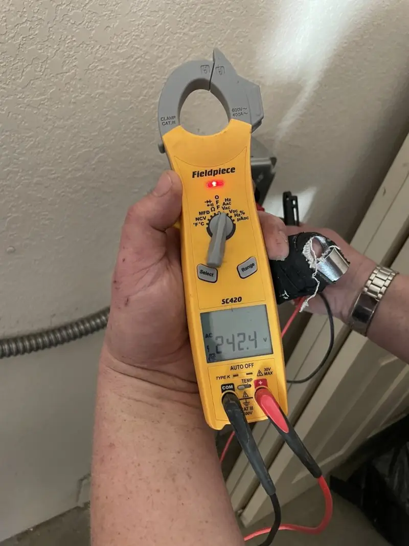 Voltage testing with clamp meter during Outlet Installation in Oceanside
